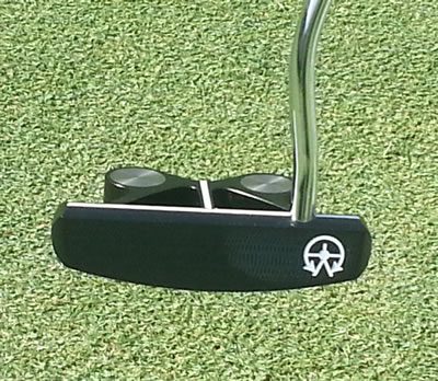 soleofputter Black putter on green putting surface.