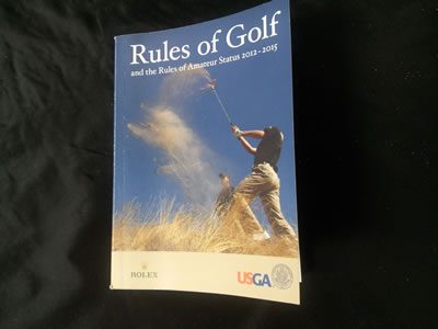 A book about rules of golf is shown.