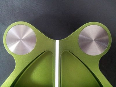 A close up of the front of a green speaker.