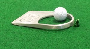 puttingcarpet Here's an alt tag for the image: Golf ball on putting aid device.