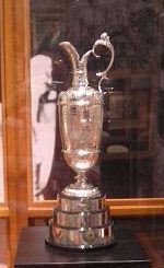 A silver trophy sitting on top of a wooden table.