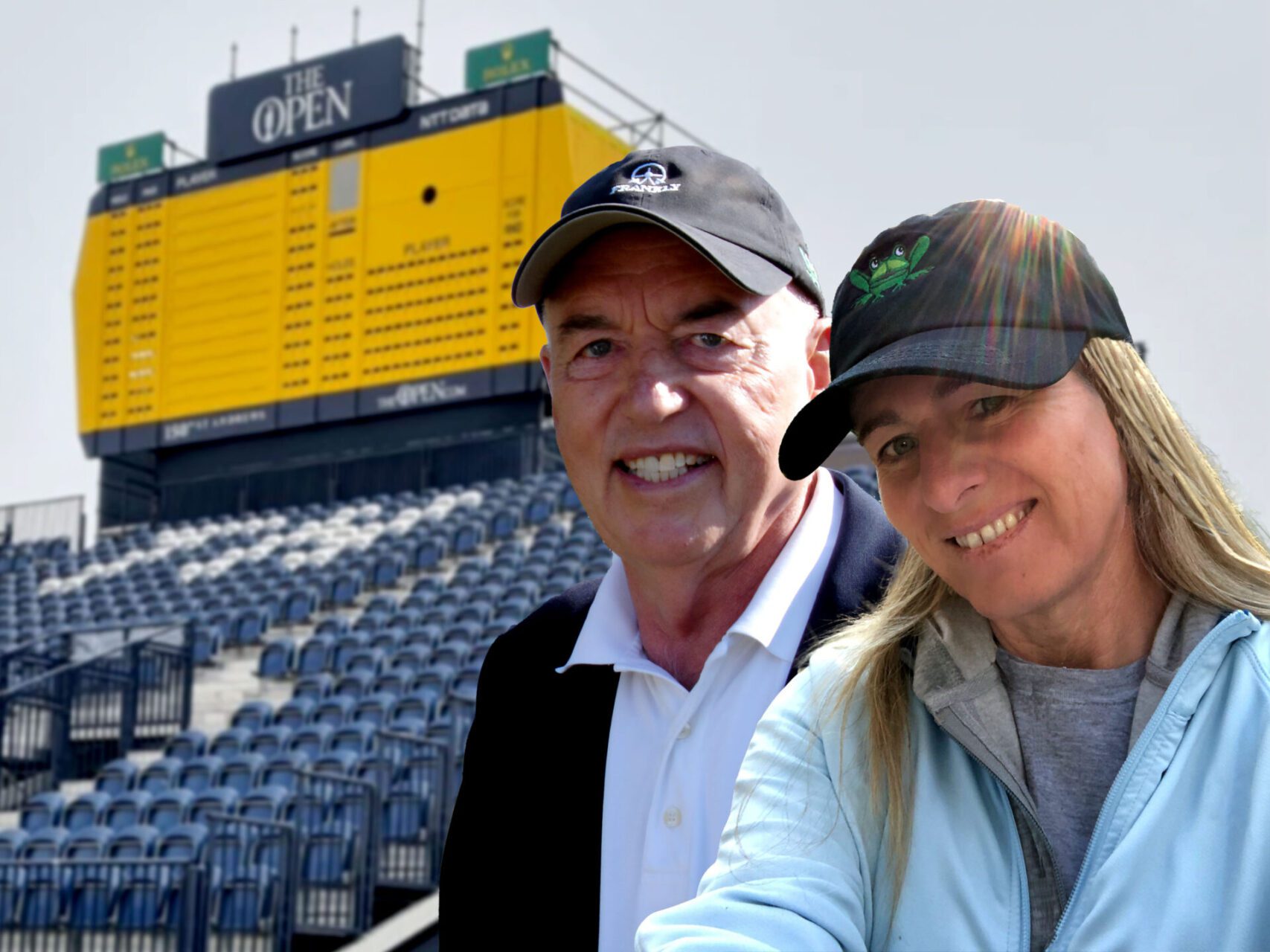 A man and woman posing for the camera in front of an empty stadium.